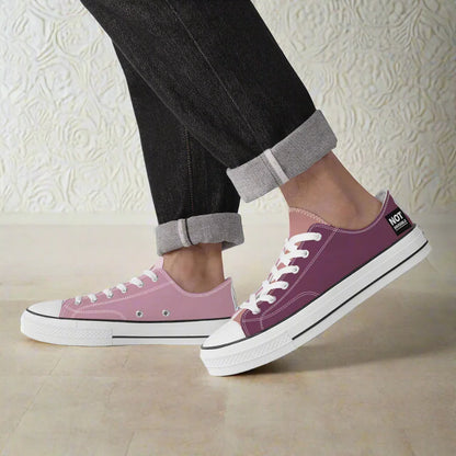 Purple sneakers with white soles worn with black pants and rolled-up cuffs on a white background