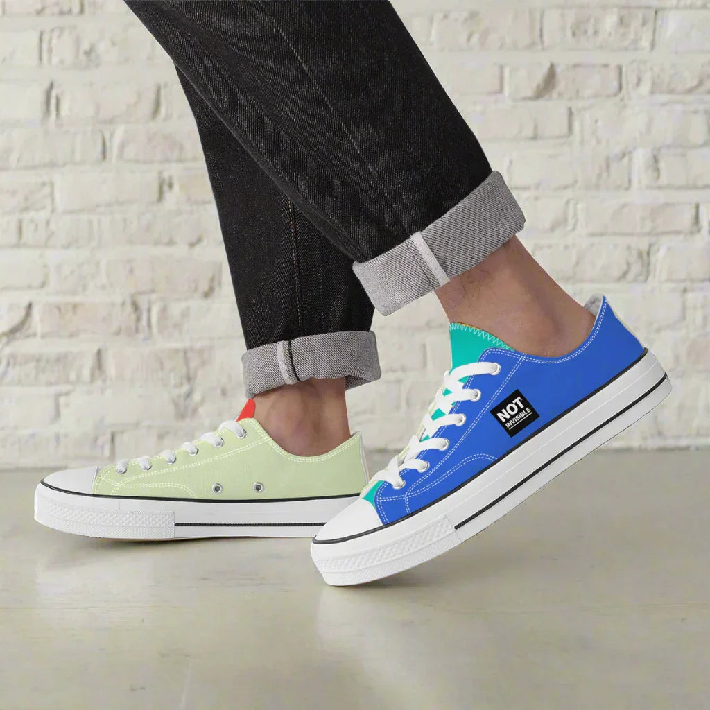 Two sneakers, one green and one blue with white soles, on a white background.