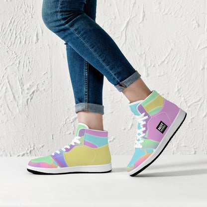 Colorful high-top sneakers worn with blue jeans against a textured white wall.