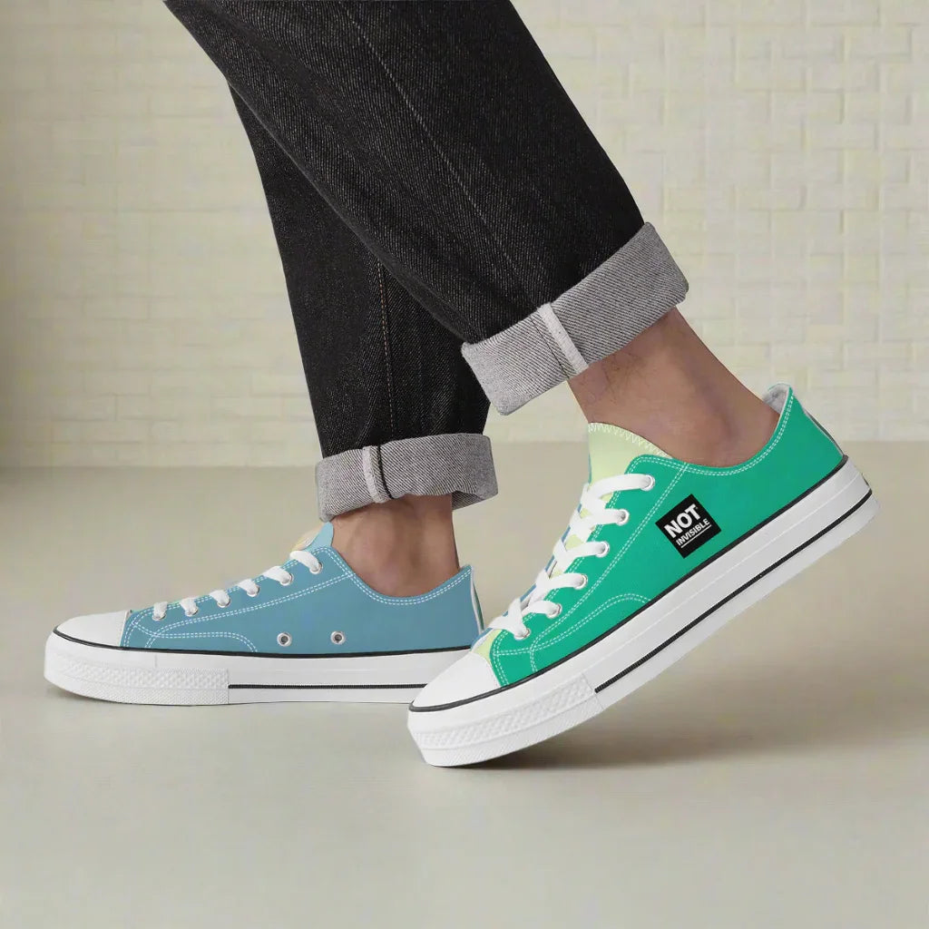 Two pairs of sneakers, one blue and one green with white soles, on a neutral background.