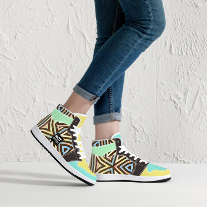Colorful patterned sneakers worn with blue jeans against a white background